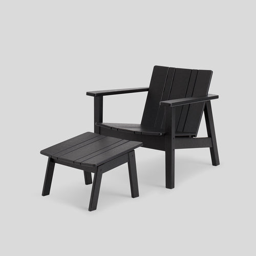 A studio photo of Low Chair Black / Chair + Ottoman