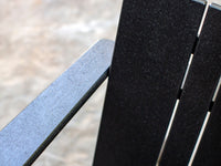 A close up detail shot of a Neighbor adirondack chair