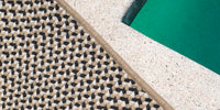 A detail shot of a Neighbor braid rug in Ebony